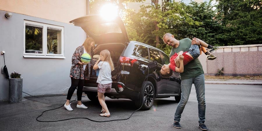 A family at home with an electric vehicle